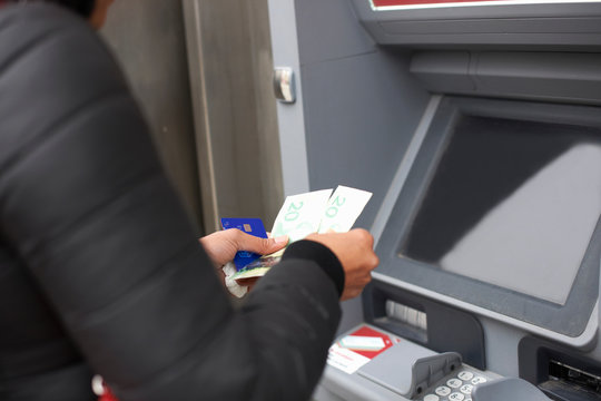 Woman using cash machine