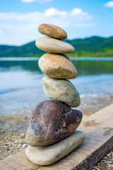 Fototapeta na wymiar Photo of stones balanced on top of eachother on a beach