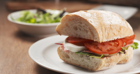Fly out reveal ciabatta sandwich with speck, mazzarella and vegetables, 4k photo