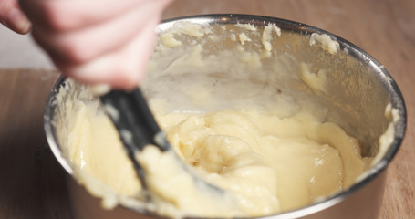 female hands mixing choux dough, 4k photo