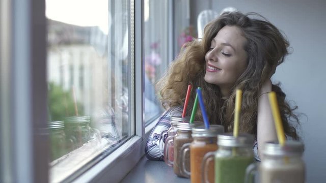 girl choosing healthy fruit colorful smoothies for drink. Dolly shot