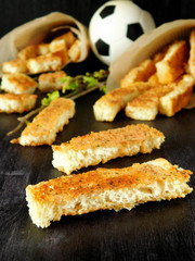 Crispy snacks in a paper bag for football match watching