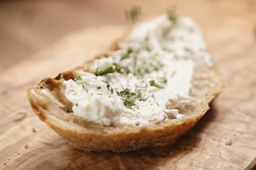 herbs on rustic bread with ricotta cheese, shallow focus