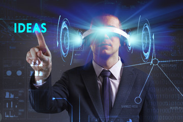 Business, Technology, Internet and network concept. Young businessman working in virtual reality glasses sees the inscription: Ideas