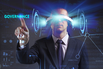 Business, Technology, Internet and network concept. Young businessman working in virtual reality glasses sees the inscription: Governance
