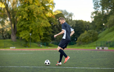 soccer player playing with ball on football field