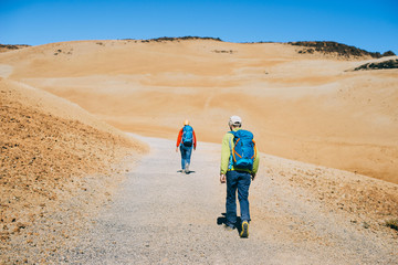 Two friends travel volcanic landscapes in the Canary Islands, Spain