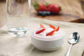 organic strawberry yogurt for breakfast, shallow focus