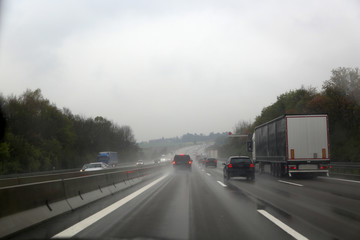 Fototapeta na wymiar Road from car window / Autobahn in rainy weather