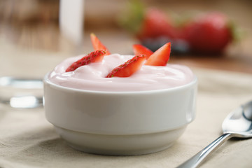 organic strawberry yogurt for breakfast, shallow focus