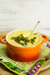 Vegetable cream soup on a light wooden background. Country style. Selective focus. Top view.