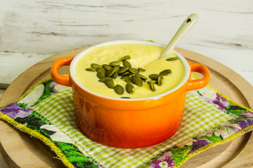 Vegetable cream soup on a light wooden background. Country style. Selective focus. Top view.