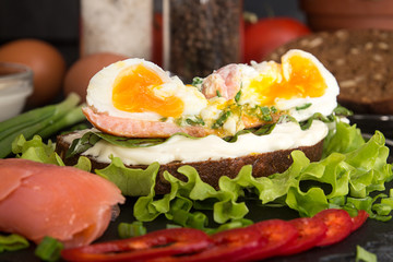 Toast with salmon, pepper, cream cheese, chives and poached egg