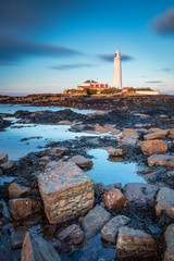 St Mary's Lighthouse in portrait / St Mary's Lighthouse on a small rocky Island, just north of Whitley Bay on the North East coast of England. A causeway submerged at high tide links to the mainland