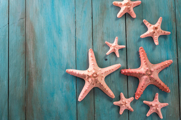 Fototapeta na wymiar Summer time sea vacation background with star fish, marine rope on dark blue background