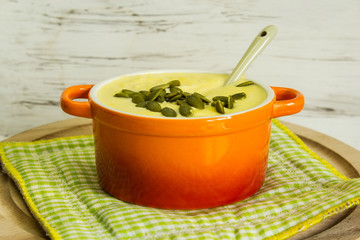 Vegetable cream soup of pumpkin, cauliflower and carrots, with pumpkin seeds. Selective focus.