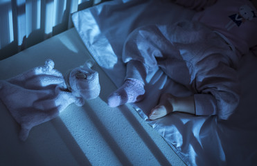 Adorable baby sleeping in blue at night