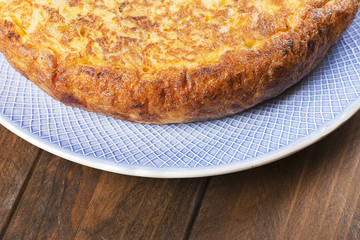 Omelette on wooden table. Typical Spanish omelette