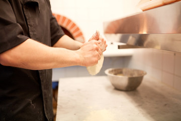 chef hands preparing dough on table at kitchen