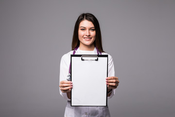 Young female doctor holding empty folder with files of desease illness. Specialist point by pen blank clipboard. Woman in medical uniform with stethoscope.