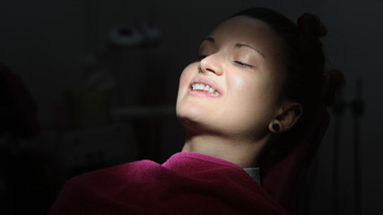 The girl at the dentist, placing brackets