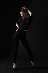 Fototapeta na wymiar Vogue dancer posing on dark background
