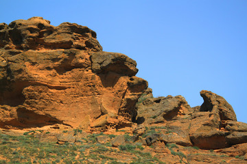 Fototapeta premium Eroded stones on Bogdo mountain, yellow limestone rocks and blue sky