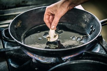 Chef is cooking mushroom