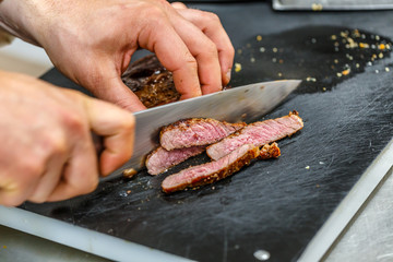 Chef is cutting meat