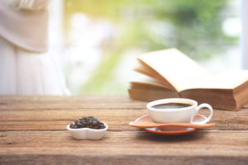 Stock Photo - Cup of coffee with books in morning on the window side