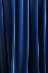 Heavy dark blue pleated textile curtain background