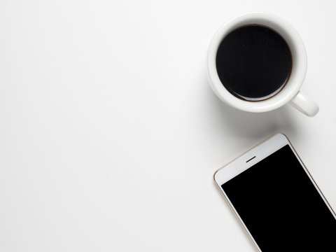 Cup Of Coffee And White Smart Phone On White Table