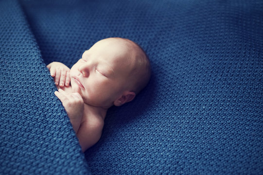 Newborn Baby Sleeping On Blue Blanket