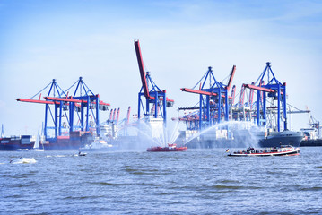 Hamburg harbor, birthday parade with various ships. View to Hamburg harbor with harbor cranes and...