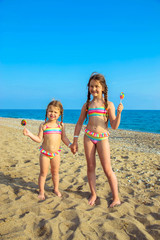 Children with colorful lollipops enjoy a summer vacation