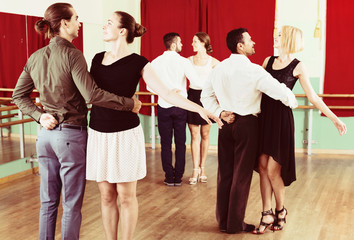 Tree smiling couples dancing waltz