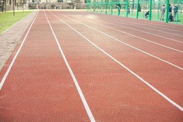 white bent lines marking red stadium with soft covering