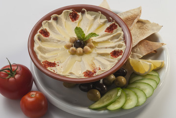 Hummus with khubz and olive with fresh vegetable salad  