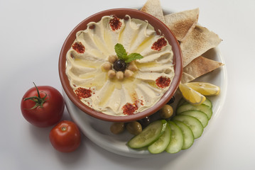 Hummus with khubz and olive with fresh vegetable salad  