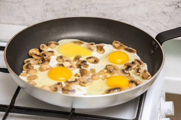 Fried eggs with mushrooms for a breakfast