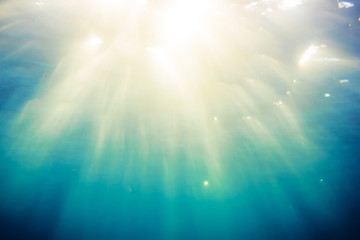 Texture of blue water in tropical ocean and sunlight. Underwater blue background