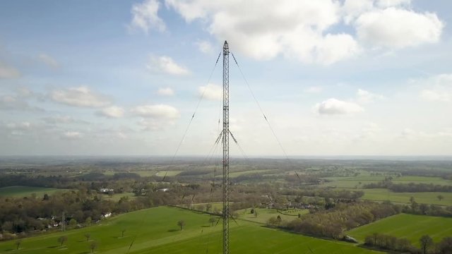 Radio mast antenna and English countryside; drone rotating