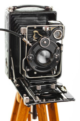 Old camera on a tripod on a white background