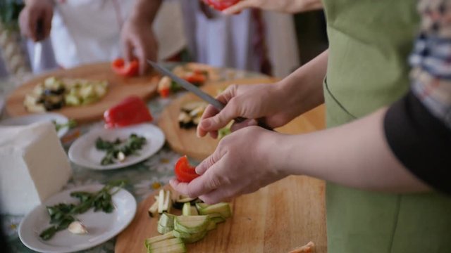 People chopping red pepper at master class