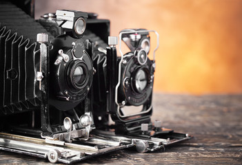 Old camera on an old background on a close-up table