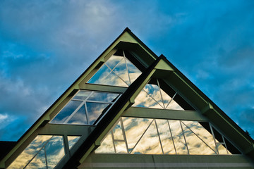 Reflection of a sky in a triangle glass shape on a building at Bled, Slovenia