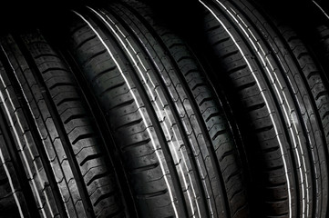 Car tires in row isolated on black