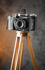 Old camera on an old background on a close-up table