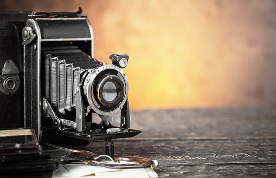 Old camera on an old background on a close-up table