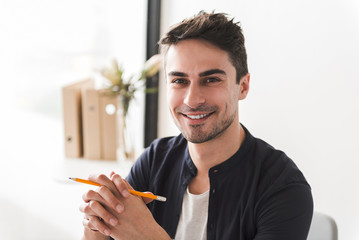 Cheerful smiling male office worker